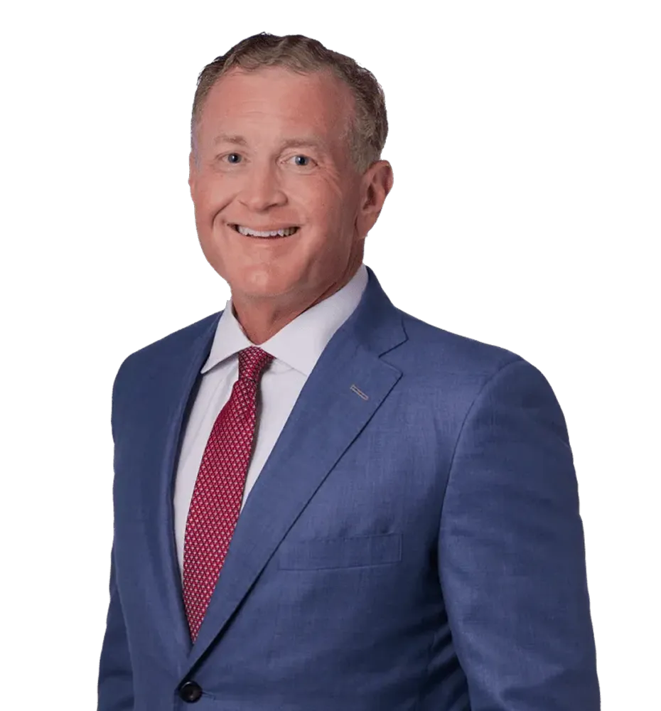 Professional portrait of a middle-aged man wearing a blue suit and red patterned tie.
